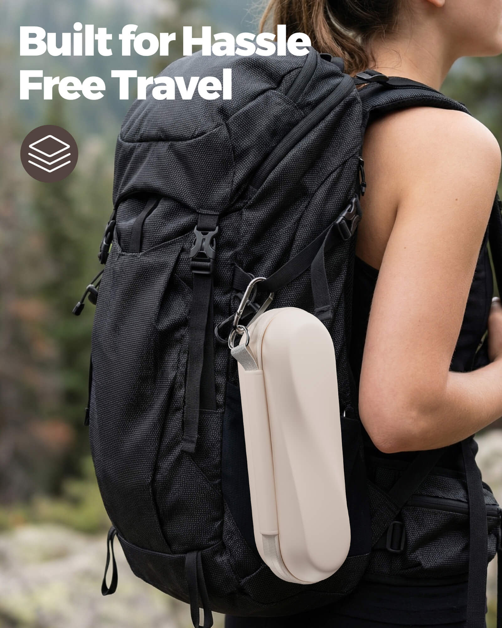 Person wearing a black backpack with a beige side pocket, set against a blurred natural background.