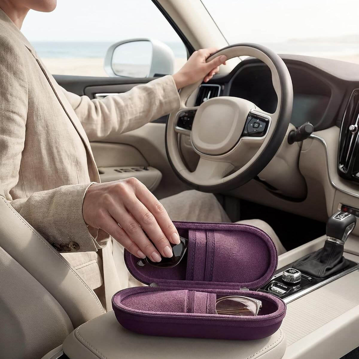 Person sitting in a car with a Hard Double Sunglasses Glasses Case for Men Women, Travel Zipper Organizer for Couple Gifts on the dashboard