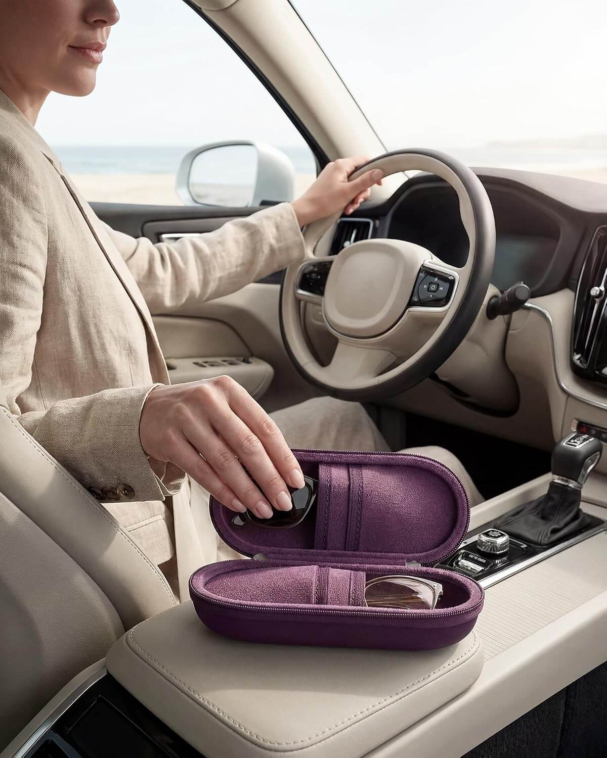Person sitting in a car with a Hard Double Sunglasses Glasses Case for Men Women, Travel Zipper Organizer for Couple Gifts on the dashboard
