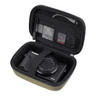 An open hard-shell digital camera case with black mesh compartments and a black strap holding a Canon G7X camera, shown on a white background.
