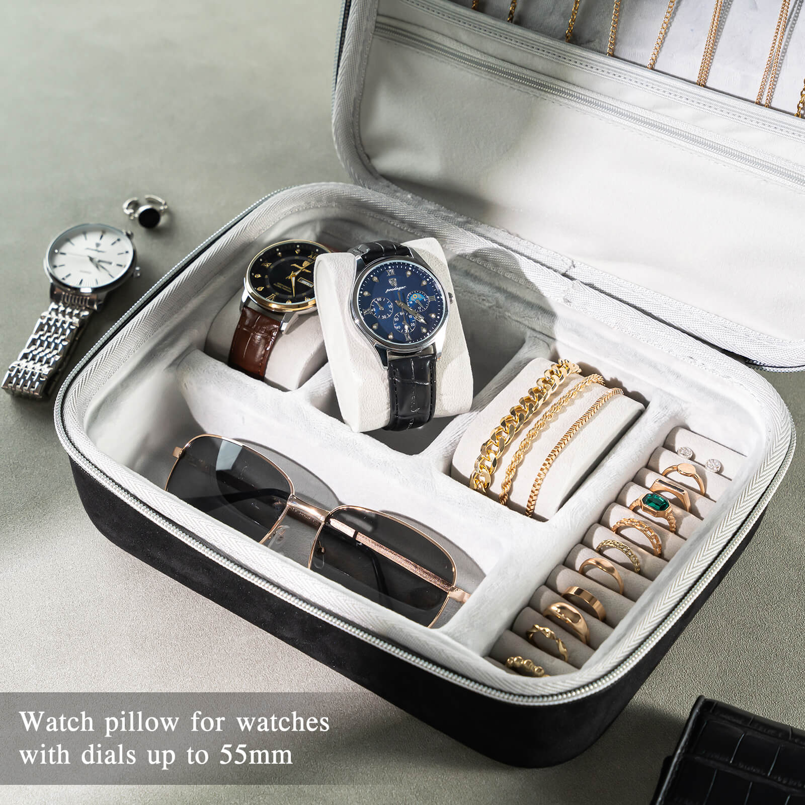 Jewelry case with watches, sunglasses, and jewelry on a light gray background