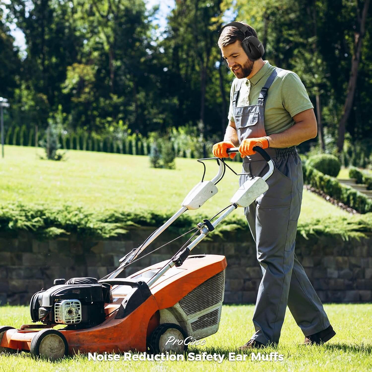 Man mowing grass with a lawnmower wearing noise reduction safety ear muffs in a garden setting.