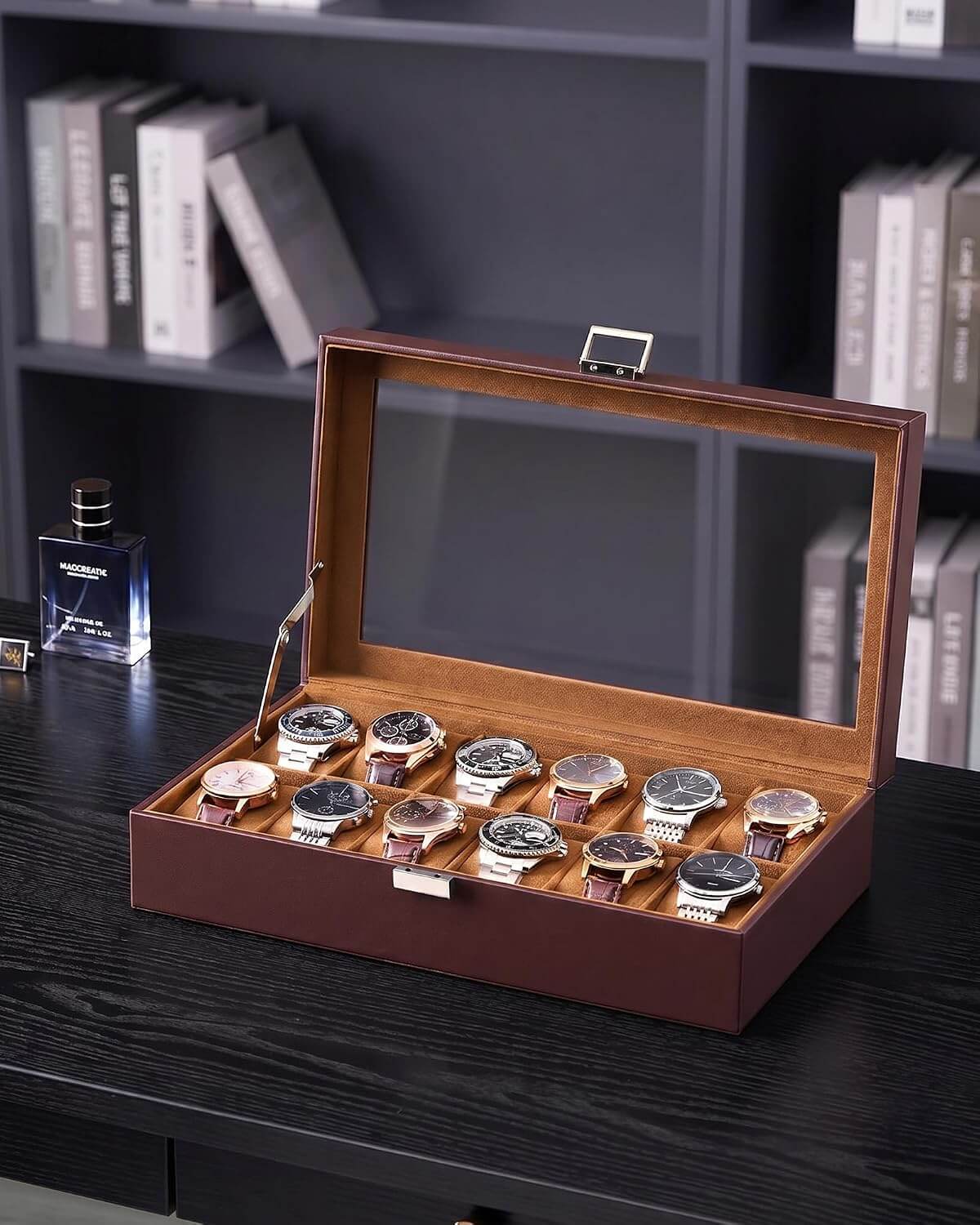 A espresso watch display box with a glass lid, shown open on a dark wooden table. Inside, ten wristwatches with silver cases and dark dials are arranged in two row