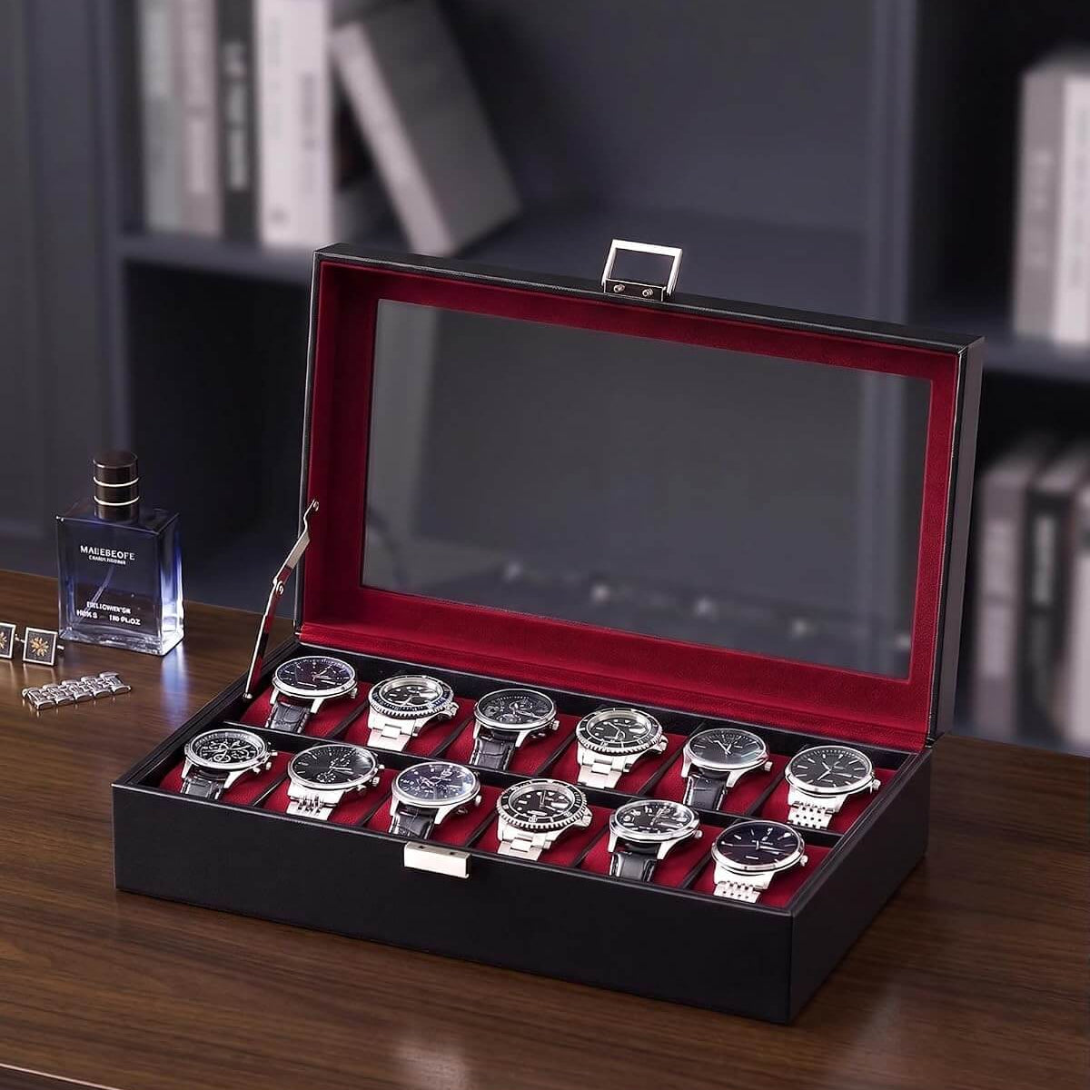 A winered watch display box with a glass lid, shown open on a dark wooden table. Inside, ten wristwatches with silver cases and dark dials are arranged in two row