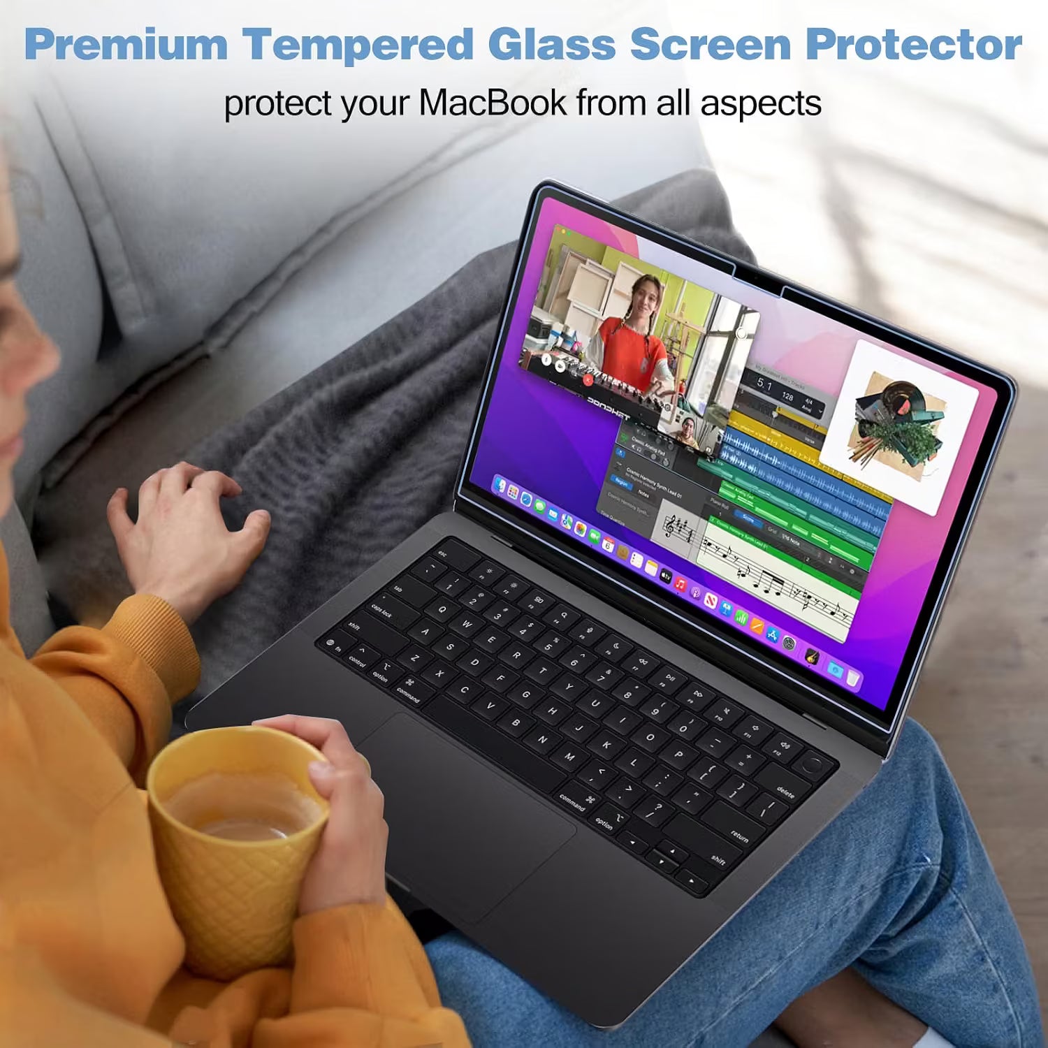 A person sitting on a gray couch holds a yellow mug while using a black laptop with a screen protector applied. Text at the top reads 'Premium Tempered Glass Screen Protector protect your MacBook from all aspects.