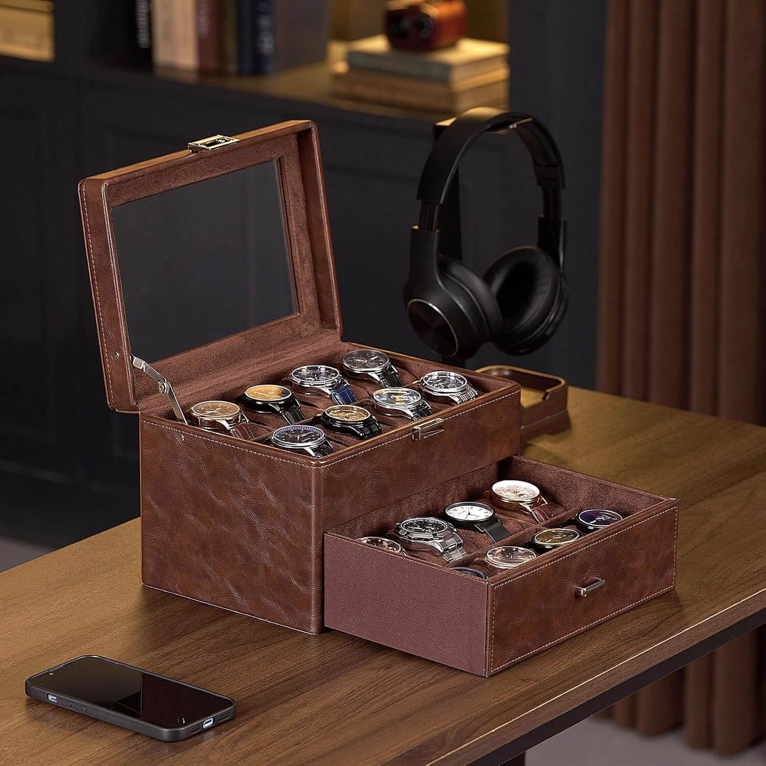 Brown leather watch box with multiple watches on a wooden table