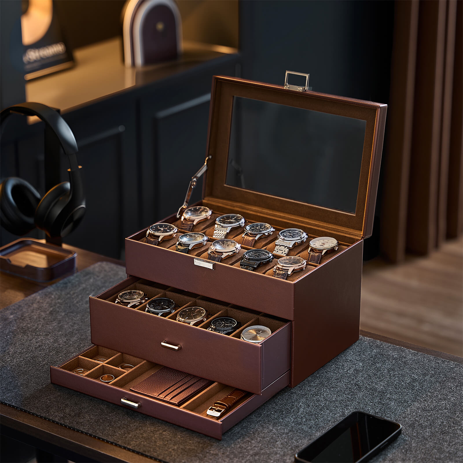 Wooden watch box with multiple watches on a desk