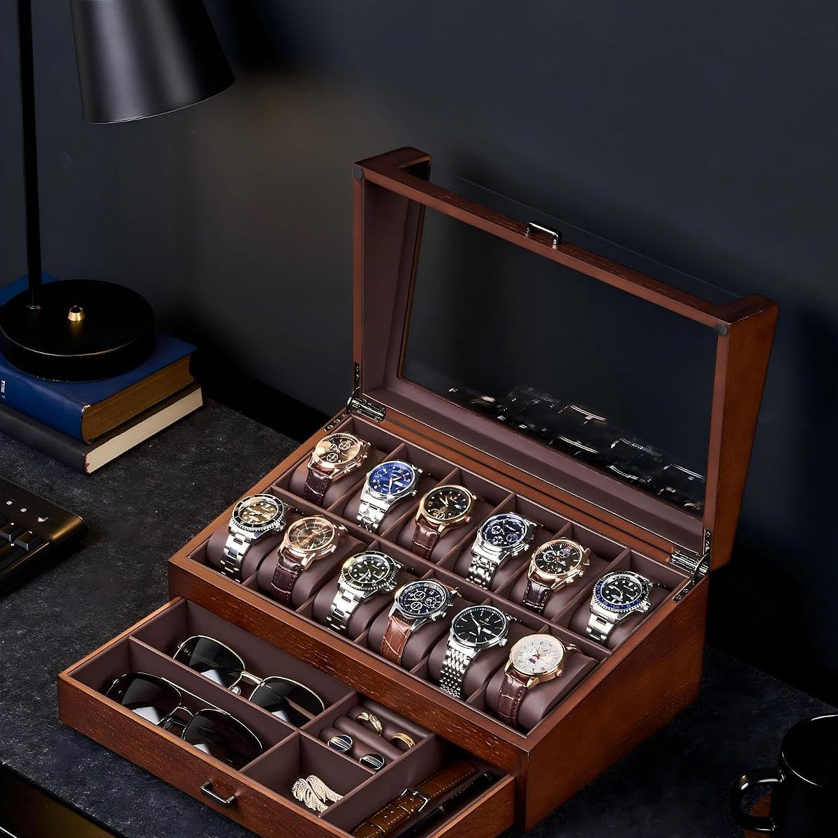 Wooden watch and jewelry display case with watches and sunglasses on a dark surface.