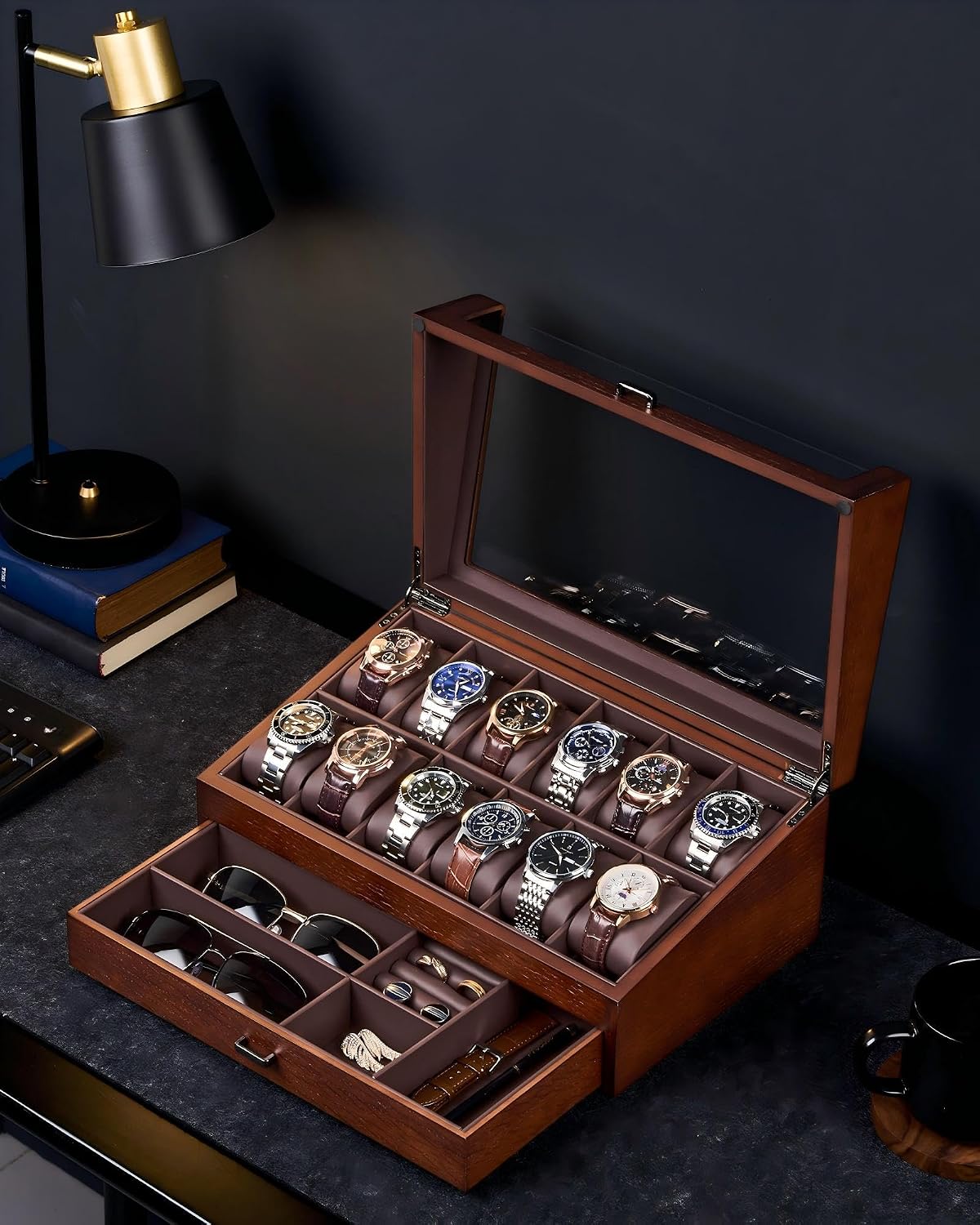 Wooden watch and jewelry display case with watches and sunglasses on a dark surface.