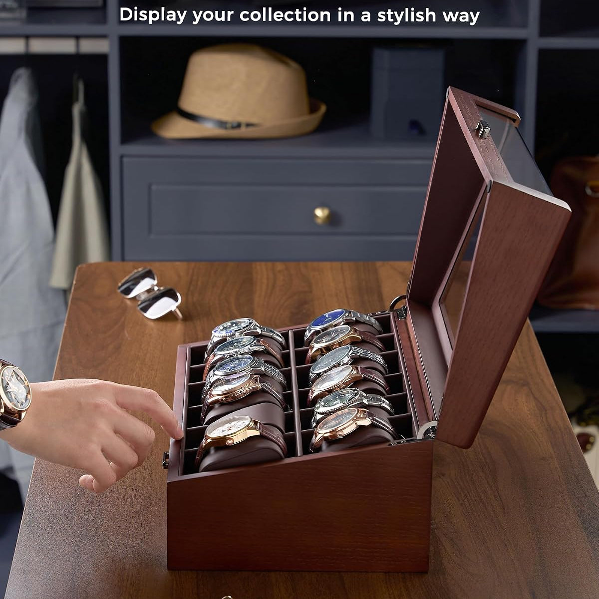 Wooden watch display case withinclined watch slot on a wooden table.
