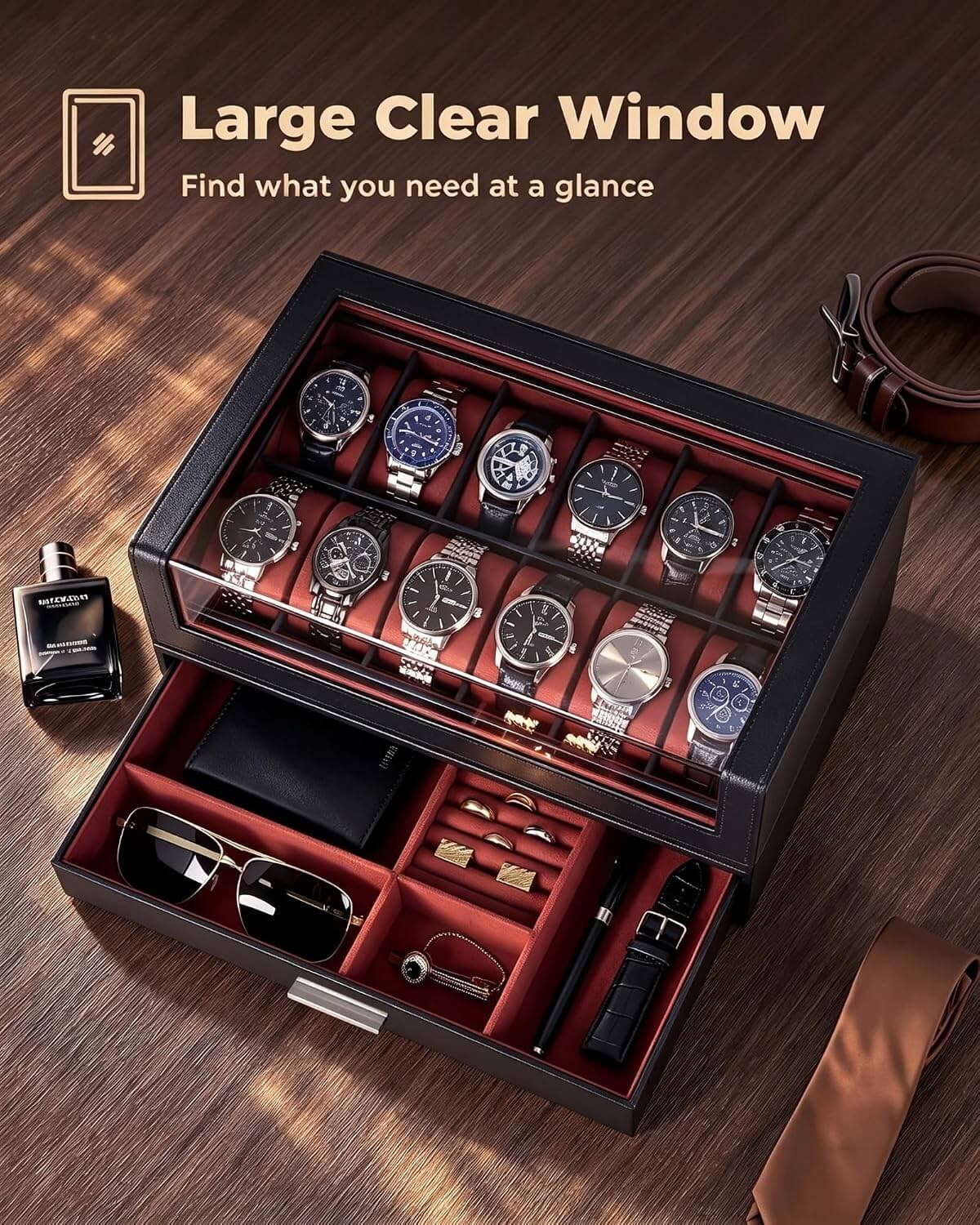 A luxury watch storage box with a clear glass top window and an open lower drawer, displayed on a wooden table. The box is black with a red interior and holds multiple wristwatches, sunglasses, a watch, and accessories.