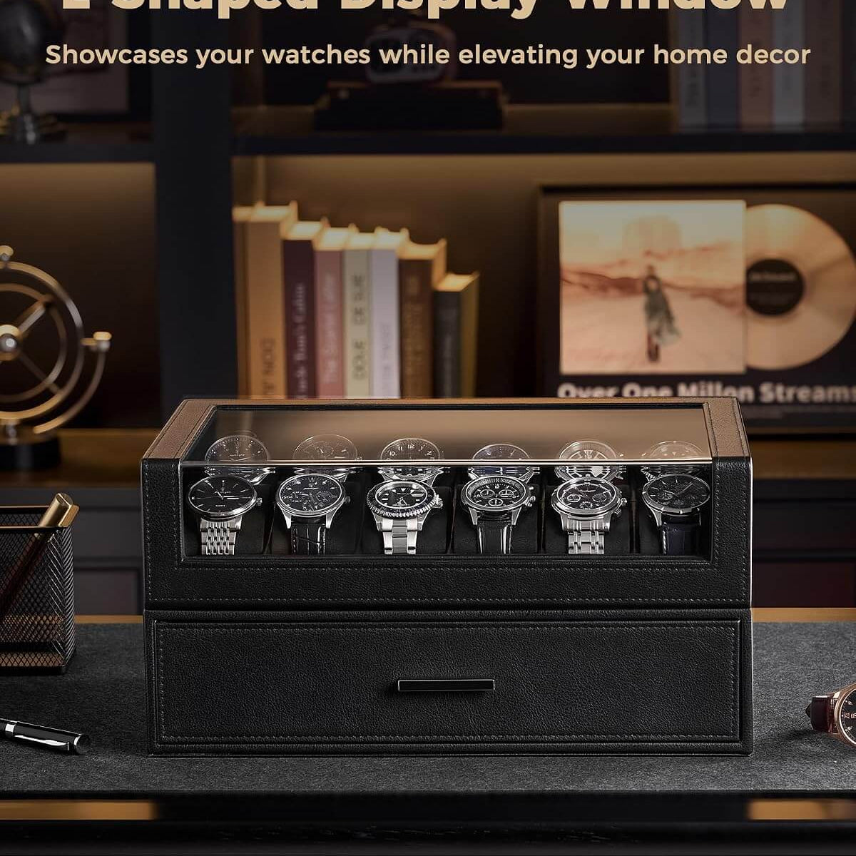 A black L-shaped watch display box with a glass top window, shown on a dark desk with several watches displayed inside. 