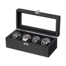 A black wooden watch display box with an open glass lid, holding four wristwatches on a plain white background.