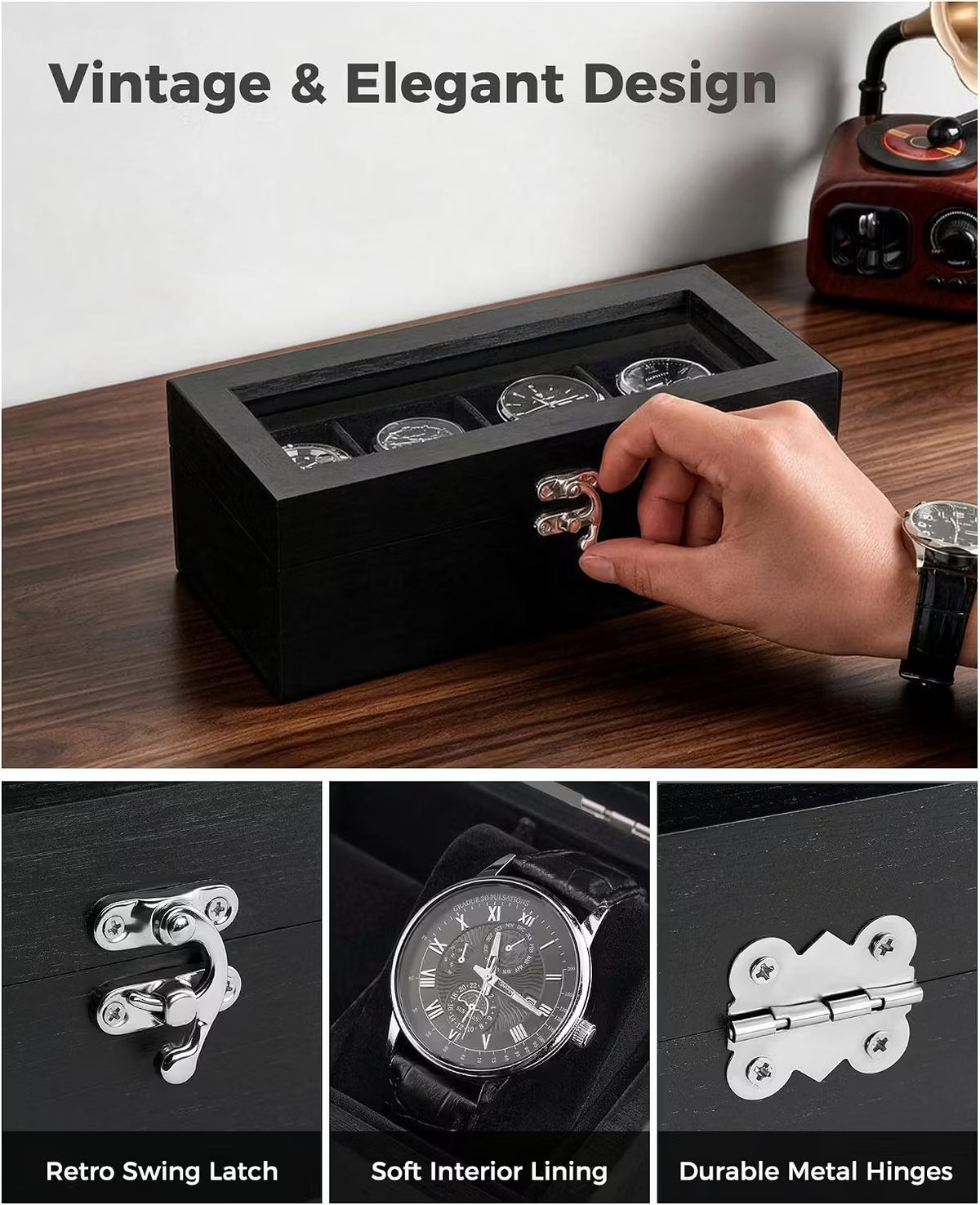 A black wooden watch display box with a transparent top and three watch slots, shown on a dark wood tabletop. A hand is opening the front latch.