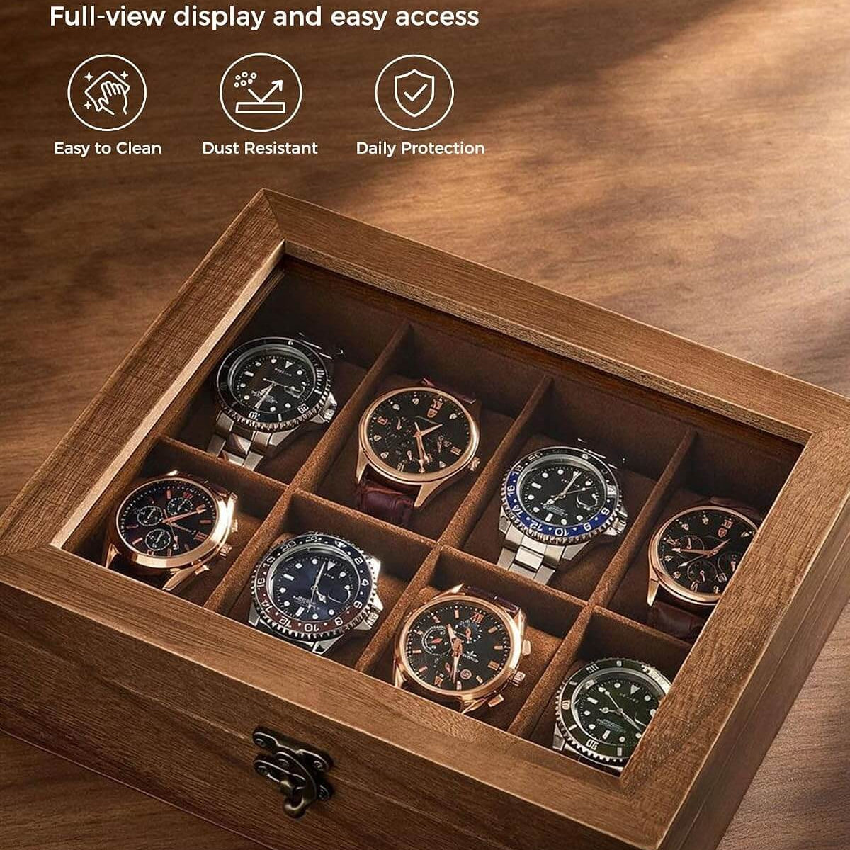 A wooden watch display box with a clear glass lid, shown open on a wooden surface. Inside are eight watch compartments holding several wristwatches.