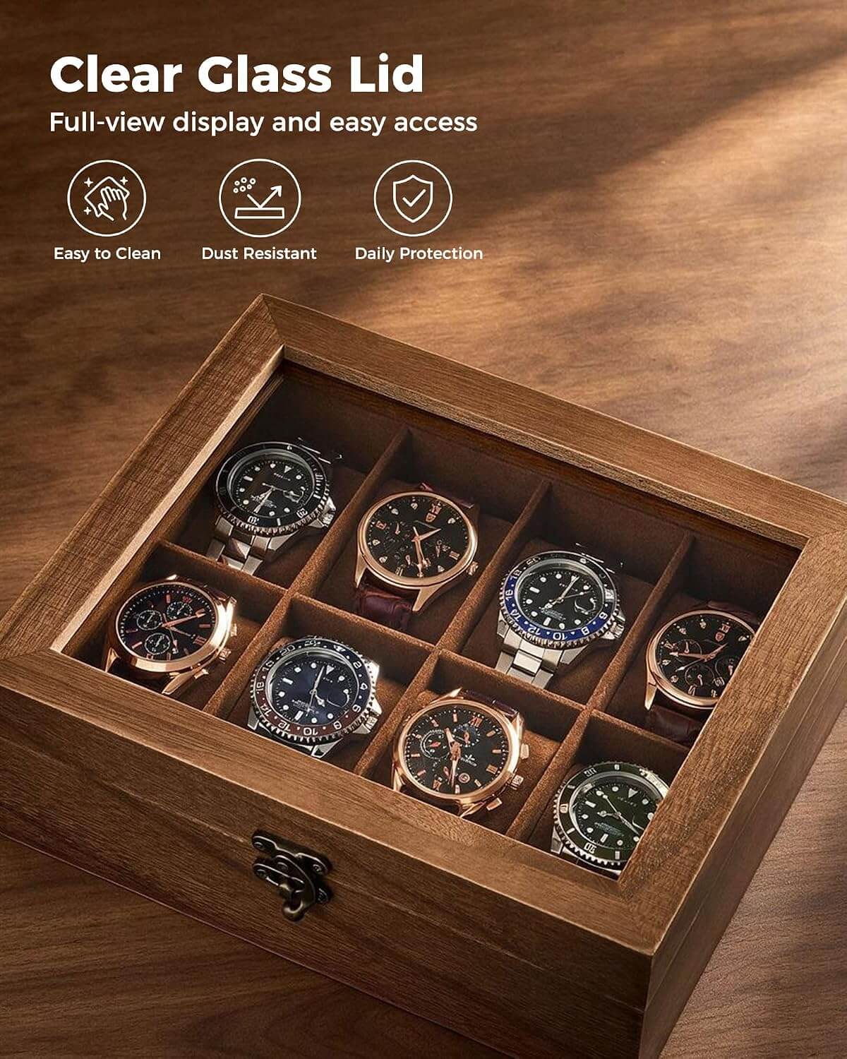 A wooden watch display box with a clear glass lid, shown open on a wooden surface. Inside are eight watch compartments holding several wristwatches.