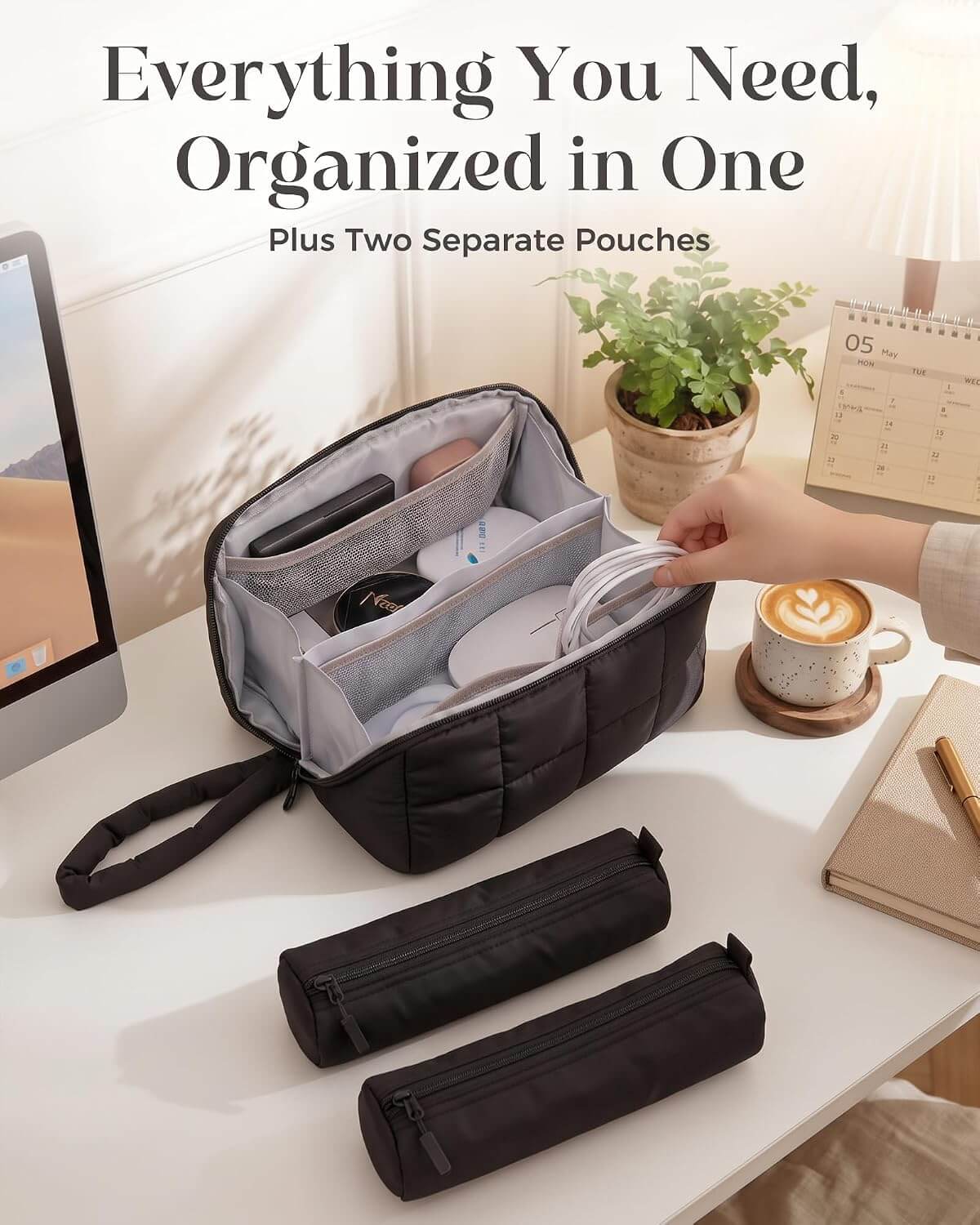 A black puffy tech pouch with a hand strap is shown open on a white desk, holding various small accessories. Two matching zip pouches are placed in front.