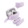 A lavender puffy tech pouch shown open with compartments filled with small toiletries, alongside two closed views of the same bag on a white background.