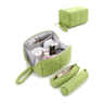 A light green puffy tech pouch shown in multiple views on a white background, including an open view with compartments and toiletries inside, a closed upright view, and two slim cylindrical pouches.